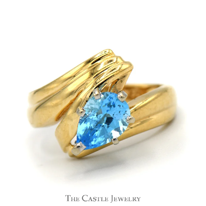 ladies rings with zircon sparkle -Pear Cut Blue Topaz Ring with Ridged Bypass Sides in 14k Yellow Gold