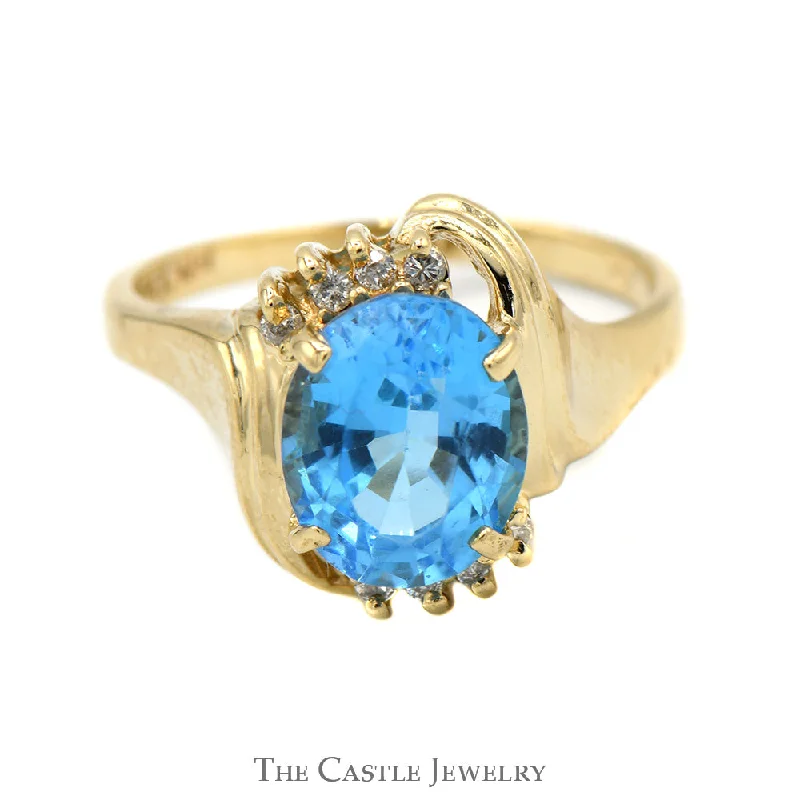 ladies rings romantic elegant design -Oval Blue Topaz Ring with Diamond Accented Bypass Mounting in 14k Yellow Gold